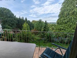 a balcony with a table and chairs and trees at Ferienwohnung Speicher in Saarbrücken