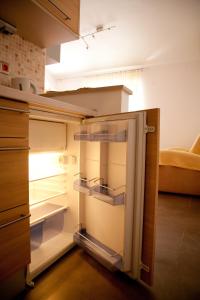 an empty refrigerator with its door open in a kitchen at Apartment Adriana in Povljana