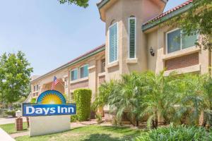 a building with a days inn sign in front of it at Days Inn by Wyndham Near City Of Hope in Duarte