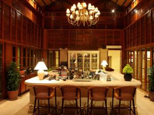 a large kitchen with a large island with chairs around it at Furama Resort Danang in Danang