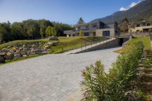 a house with a stone driveway in front of a house at Balibà Ride & Relax in Castione Andevenno