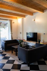 a living room with a couch and a tv at 9b-The Resort in Sežana