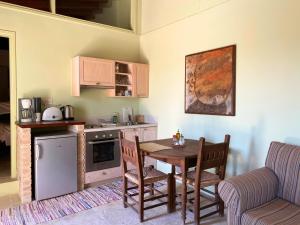 a kitchen with a table and a couch and a table and chairs at Eveleos Country House in Tochni