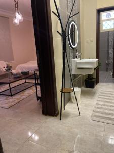 a bathroom with a sink and a mirror at شقة فندقية عوائل ثلاث غرف نوم وغرفة معيشة ومطبخ ومدخل خاص in Riyadh Al Khabra