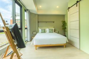 Postel nebo postele na pokoji v ubytování Chamemon Bed Phuket Town