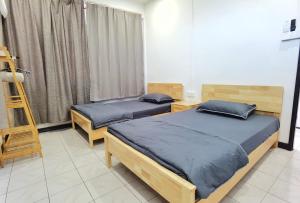 two twin beds in a room with a ladder at 3 mins to Garden City & Kubota Jln Chong Thien Vun in Tawau