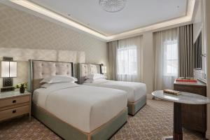 a hotel room with two beds and a table at Great Scotland Yard Hotel, part of Hyatt in London
