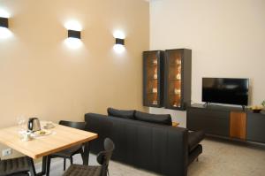a living room with a couch and a table and a tv at Casa Vacanze Ida in Cetara