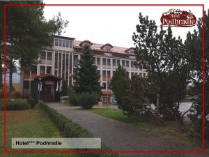 a building with a sign on the front of it at Hotel Podhradie in Považská Bystrica