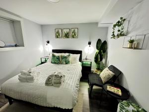 a bedroom with a bed and a chair at Palm Suite St Johns - Luxury One Bedroom Apartment in St. John's