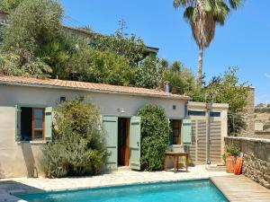 a villa with a swimming pool in front of a house at Eveleos Country House in Tochni