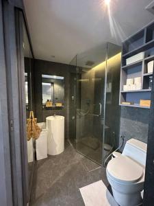 a bathroom with a glass shower and a toilet at Luxury one apartment for rent Kamala in Kathu