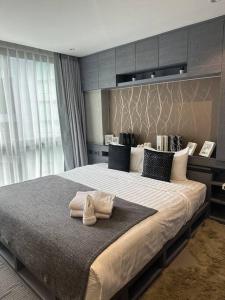 a bedroom with a large bed with towels on it at Luxury one apartment for rent Kamala in Kathu