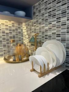 a kitchen counter with white plates on a shelf at Luxury one apartment for rent Kamala in Kathu