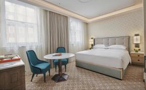 a hotel room with a bed and a table and chairs at Great Scotland Yard Hotel, part of Hyatt in London +82 photos