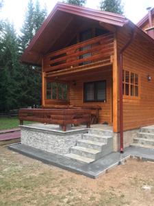 a log cabin with stairs leading up to it at Ski Chalet Jahorina in Jahorina