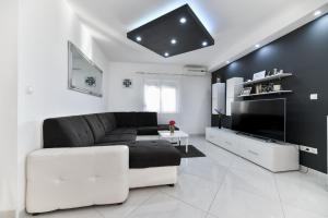 a living room with a couch and a tv at Villa Bella in Kruševo