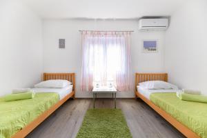 two beds in a room with a window at Villa Bella in Kruševo +39 photos