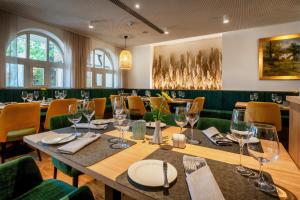 a dining room with a table with wine glasses at Vila Vita Pannonia in Pamhagen