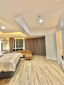 a bedroom with a bed and a couch in it at Apartmen Sea View Lampung Mall 