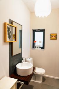 a bathroom with a tub and a toilet and a sink at Luxurious eclectic home in a traditional village in Tarxien