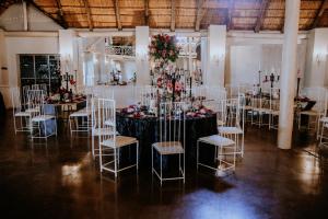a room with a table with chairs and flowers at Siesta Guesthouse & Wedding Venue - Frankfort in Frankfort +140 photos