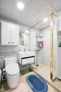 a bathroom with a toilet and a sink and a shower at Garosugil Homestay - Female Only in Seoul