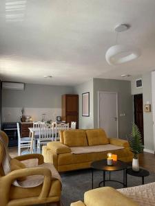 uma sala de estar com um sofá e uma mesa em Etern Stays - Nook Apartment em Pristina
