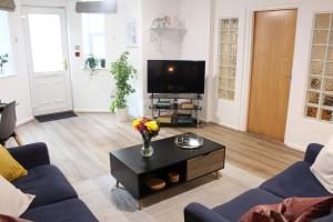 a living room with a couch and a coffee table at Flat 1, Westhill in Leeds