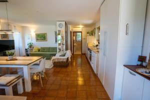 a kitchen and a living room with a table and chairs at Violet's Place in Črni Kal +16 photos