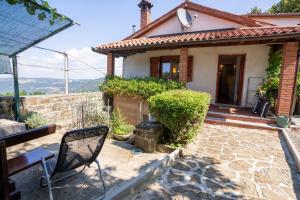 a house with a table and a chair in front of it at Violet's Place in Črni Kal