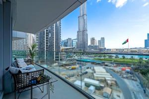 a balcony with a view of a city from a building at Vogue Downtown - Opera Grand - Burj Khalifa & Fountain Views in Dubai