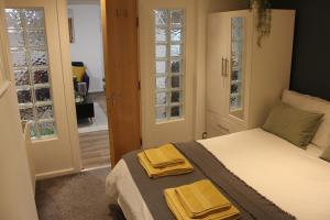 a bedroom with a bed with two towels on it at Flat 1, Allerton House in Leeds