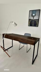 a wooden desk with a lamp and a chair at UYANA Boutique Hotel and Retreat ADULTS ONLY in Ahangama
