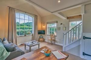 a living room with a couch and a table at The Pump House At Wiston Estate in Ashington
