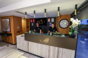 two men standing behind a counter in a restaurant at Broyt Hotel in Istanbul