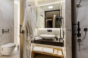 a bathroom with a sink and a toilet and a mirror at Broyt Hotel in Istanbul