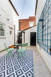 a patio with a table and chairs on a rug at Park View in Great Yarmouth