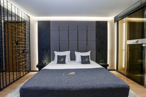 a bedroom with a large bed with blue sheets and pillows at Broyt Hotel in Istanbul
