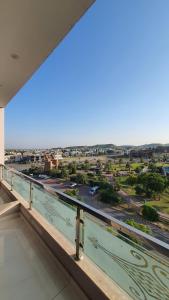 a balcony with a view of a city at Citi Hotel Apartments in Jhelum