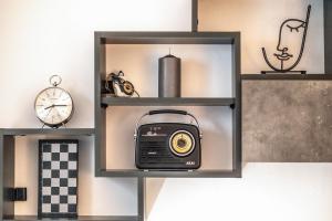 a shelf with a radio and other items on it at Minimalistic! in Athens