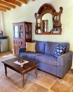 a living room with a blue couch and a table at Eveleos Country House in Tochni