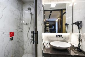 a bathroom with a sink and a shower at Broyt Hotel in Istanbul