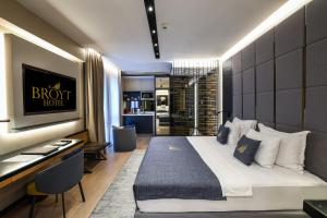 a hotel room with a bed and a desk and a kitchen at Broyt Hotel in Istanbul