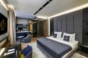 a bedroom with a king sized bed and a living room at Broyt Hotel in Istanbul