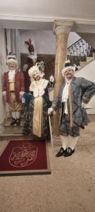 a group of statues of people dressed in costumes at Ca' Bragadin e Carabba in Venice +50 photos