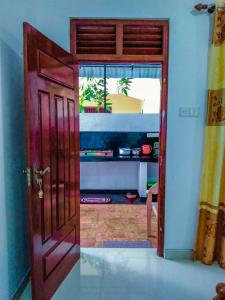 an open door to a living room with a view at Bloom Guest House in Mirissa