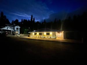 a house lit up at night with lights at The Estate HomeStay in Attigundi