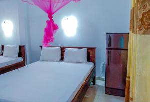 Postel nebo postele na pokoji v ubytování Bloom Guest House