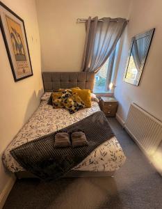 a small bedroom with a bed with yellow pillows at Long term offers Message for prices Sleeps 6 Adults, Contractors, Relocators, Travellers in Halifax